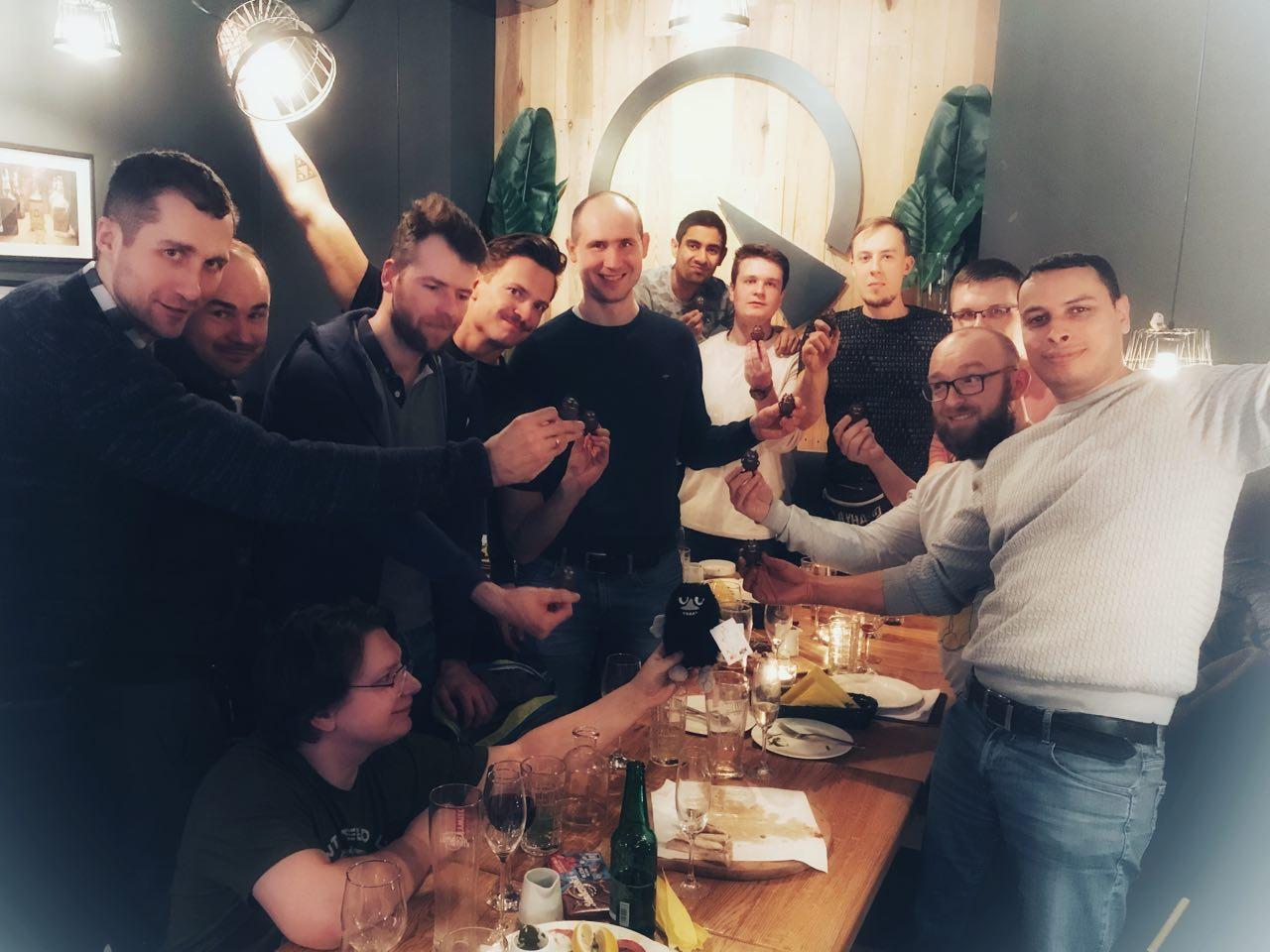 Krzysztof Synak's team celebrating together at a dinner